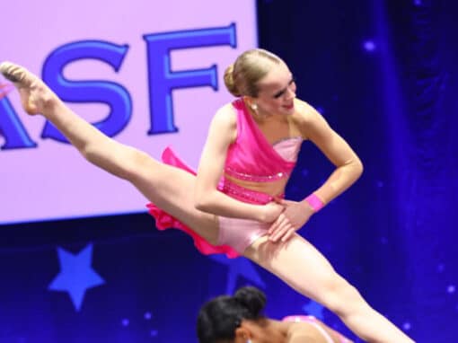Two dancers performing a dance step where she jump off. Two dancers performing a dance step where she jump off.